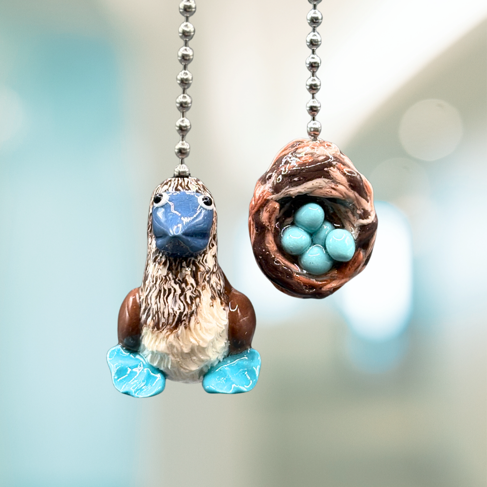 Two decorative ceiling fan pull chains with bird and nest design.