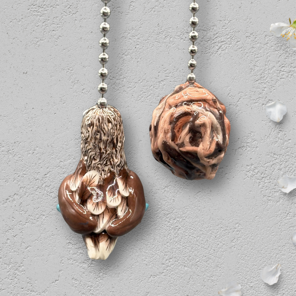 Two decorative ceiling fan pull chains with bird and nest design.