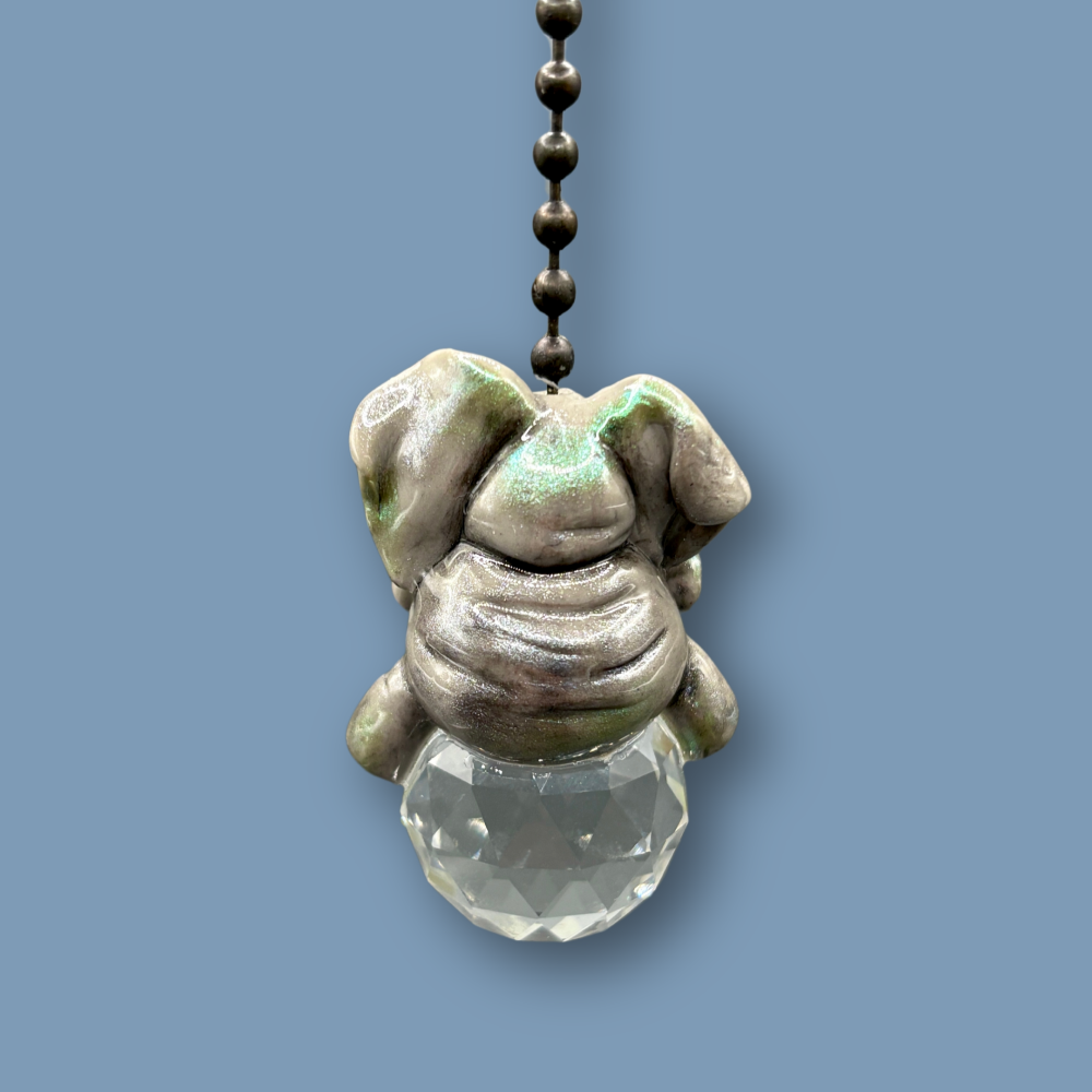 African Elephant light pull with crystal ball. Handmade with polymer clay. Elephant is Grey colored with silver and metallic green sheen sitting on a clear crystal ball