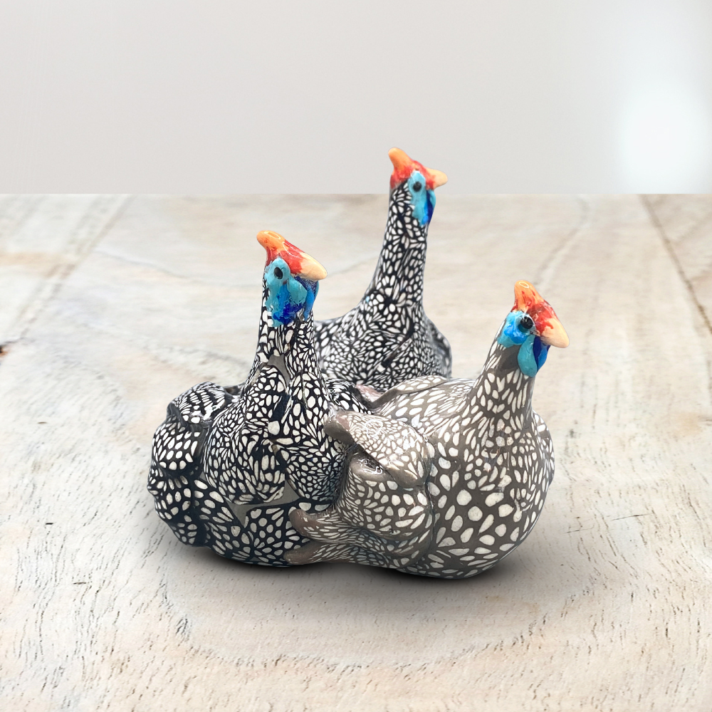 A sculpture of 3 Guinea Fowl adults made with Polymer clay