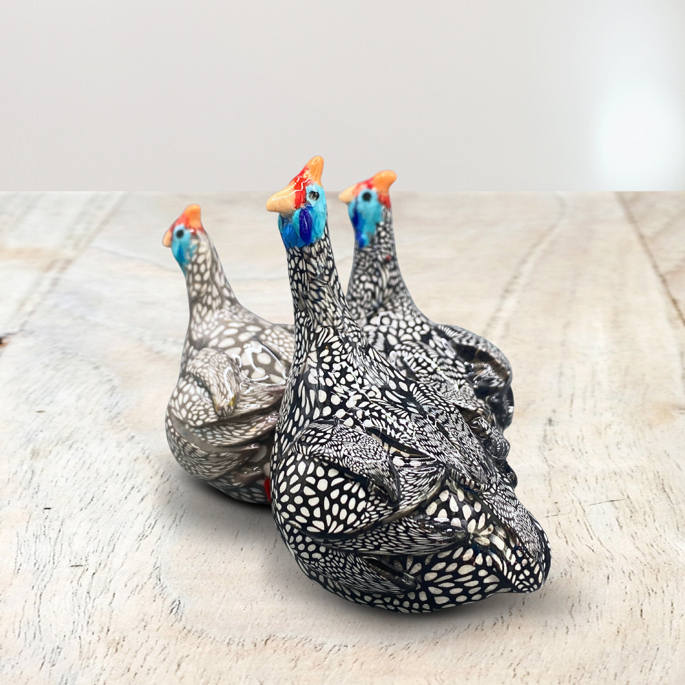 A sculpture of 3 Guinea Fowl adults made with Polymer clay