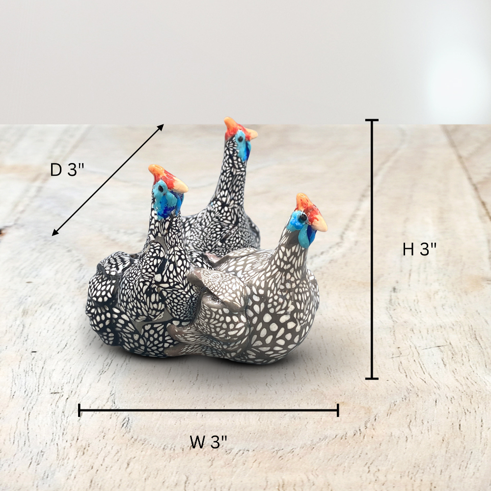 A sculpture of 3 Guinea Fowl adults made with Polymer clay