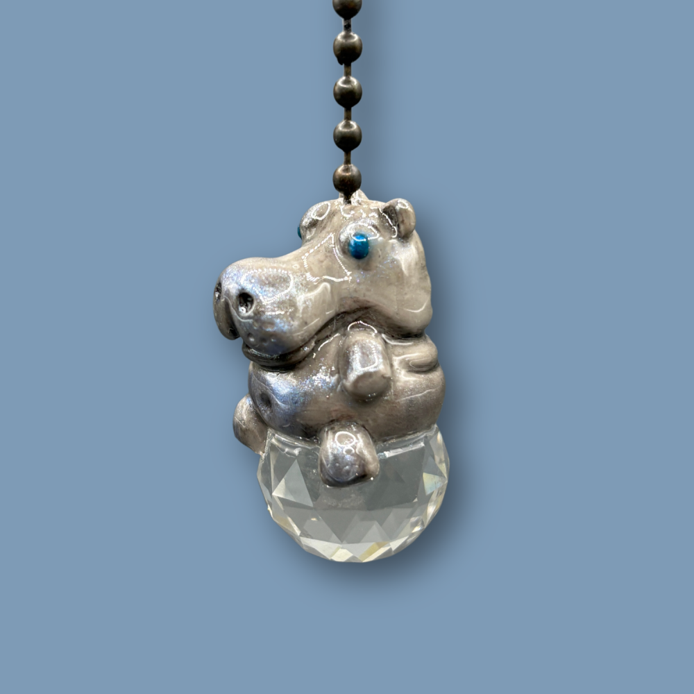 Hippopotamus light pull with crystal ball. Handmade with polymer clay. Hippopotamus is Grey colored with silver and metallic blue sheen sitting on a clear crystal ball