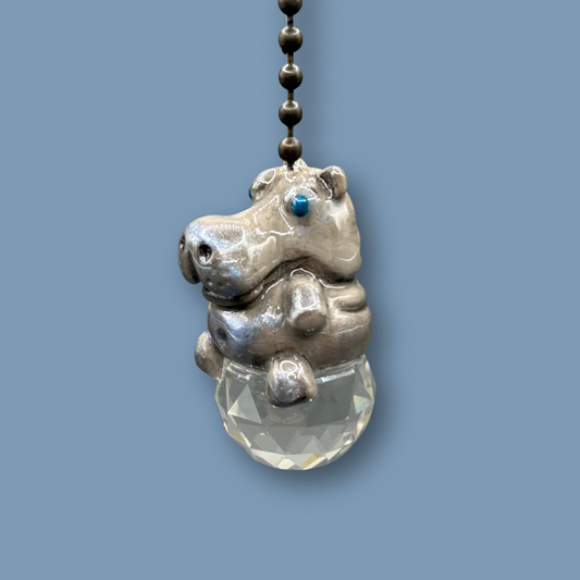 Hippopotamus light pull with crystal ball. Handmade with polymer clay. Hippopotamus is Grey colored with silver and metallic blue sheen sitting on a clear crystal ball
