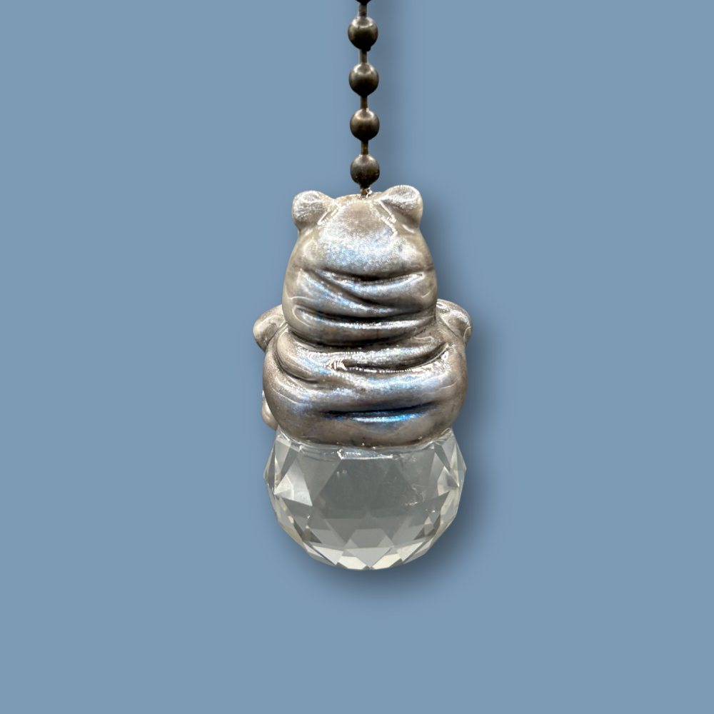 Hippopotamus light pull with crystal ball. Handmade with polymer clay. Hippopotamus is Grey colored with silver and metallic blue sheen sitting on a clear crystal ball