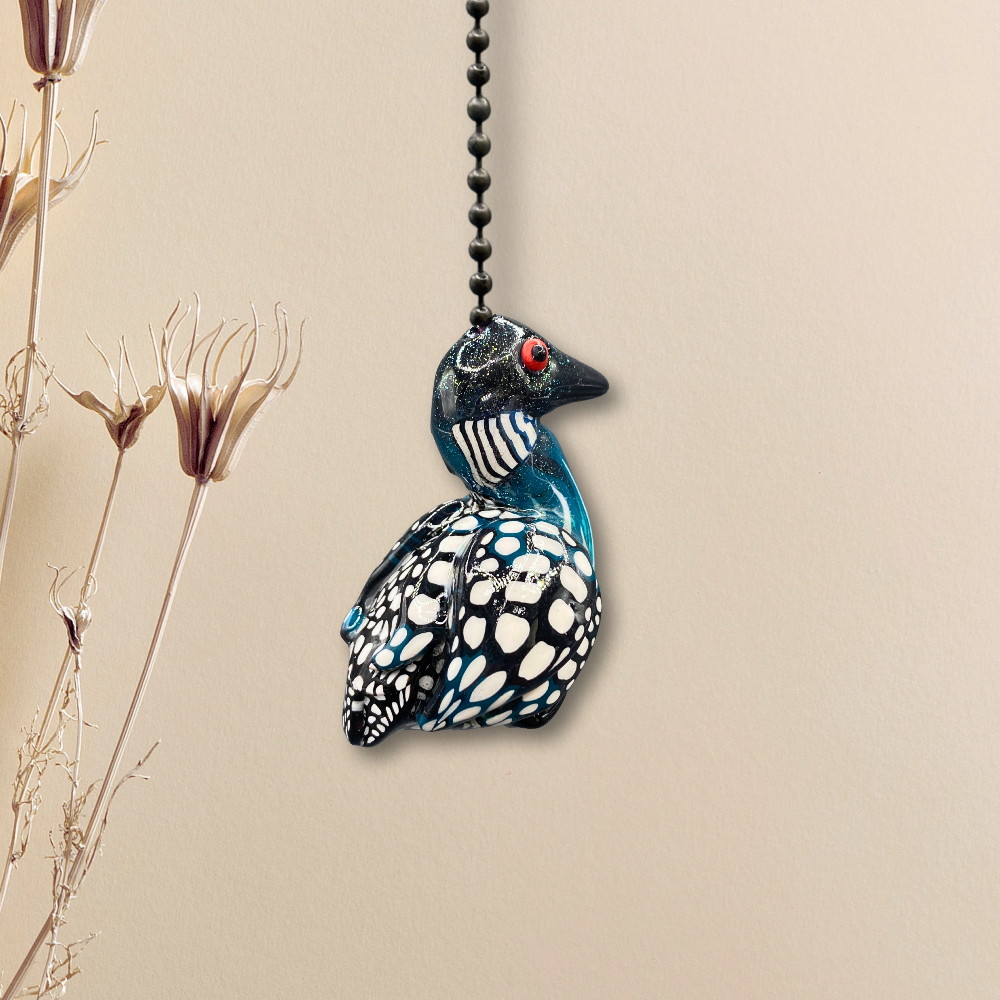 A handmade Loon charm used as a light or fan pull.