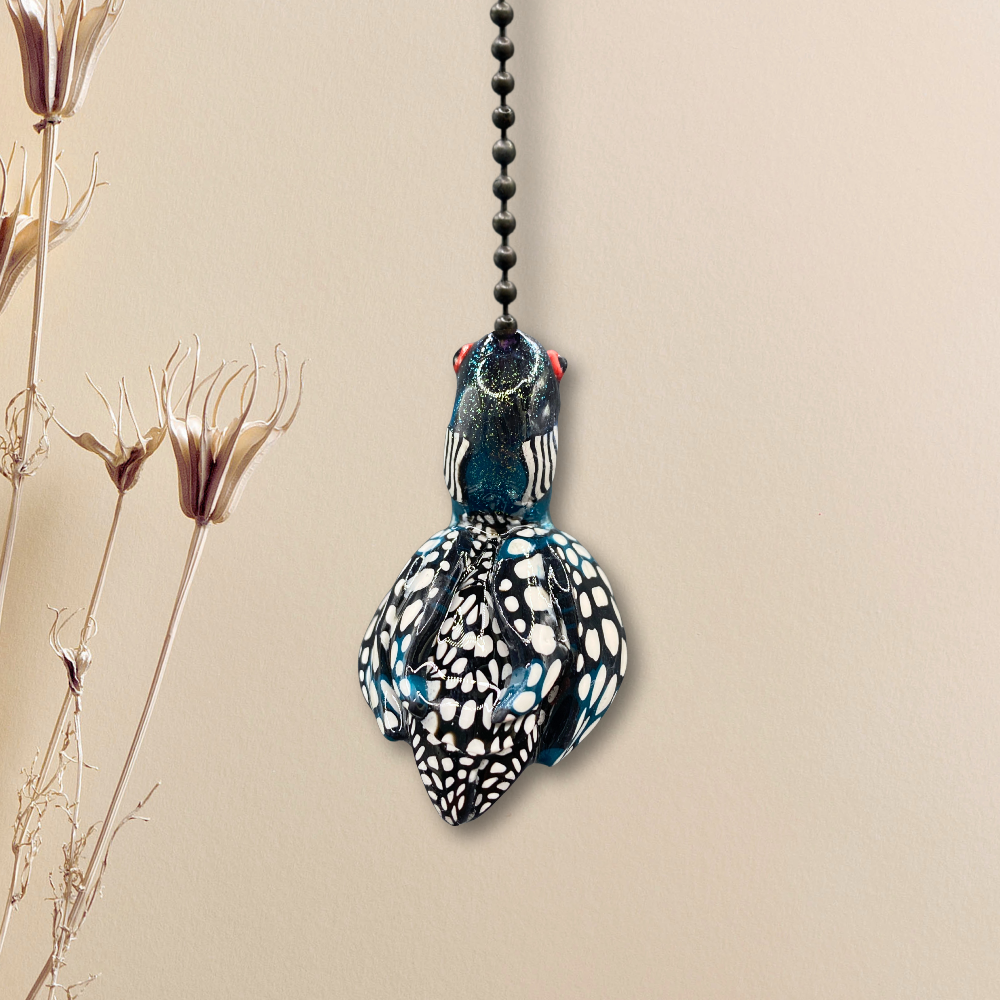 A handmade Loon charm used as a light or fan pull.