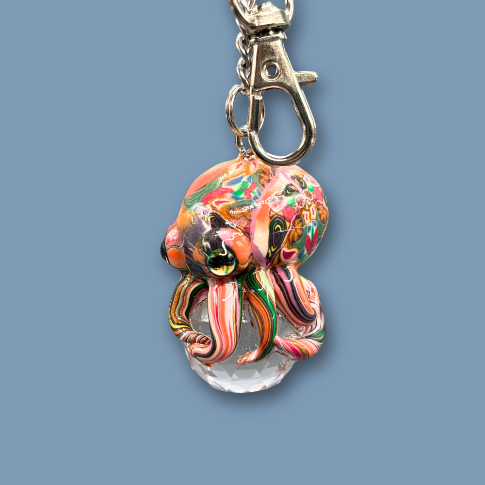 This beautiful multicolored Octopus Crystal keychain with Orange over tone, is also available as car charm. Handmade with polymer clay .