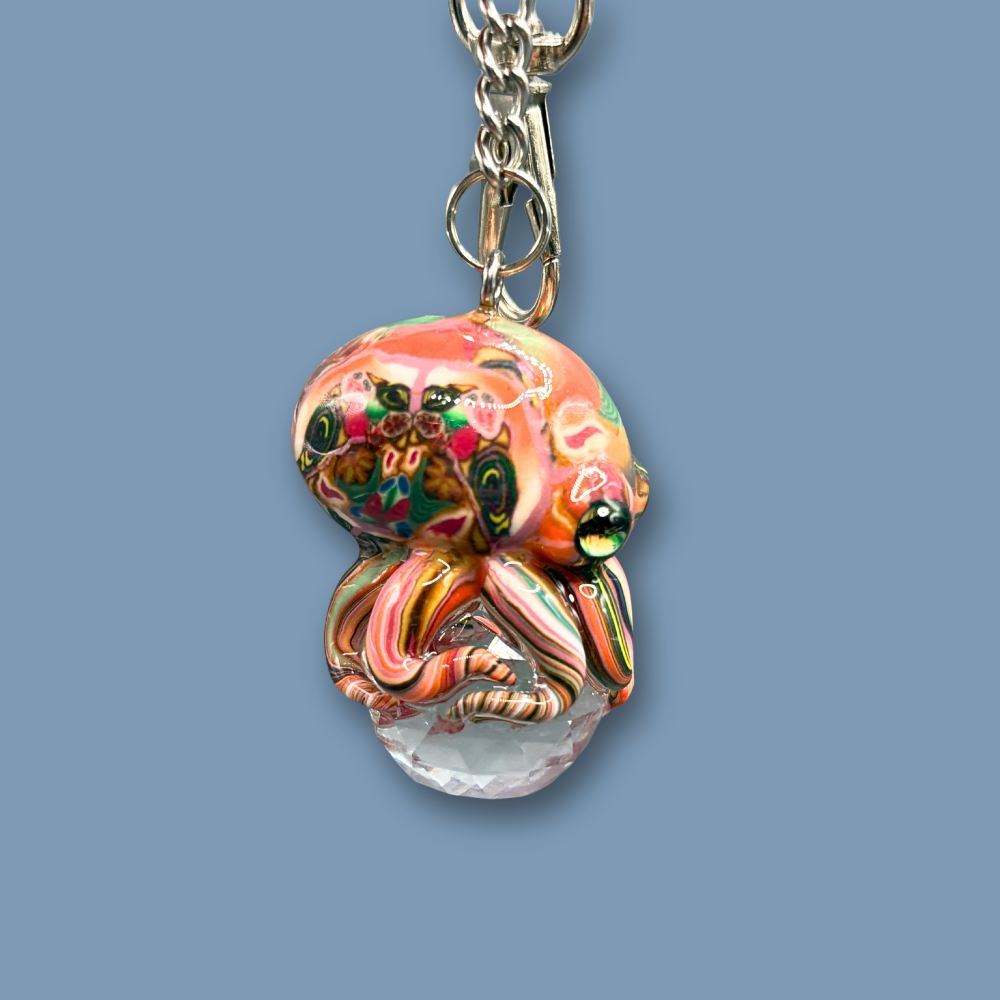 This beautiful multicolored Octopus Crystal keychain with Orange over tone, is also available as car charm. Handmade with polymer clay .