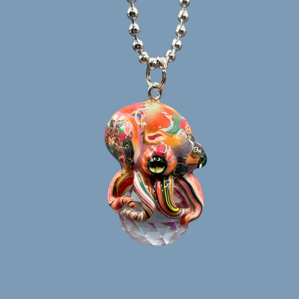 This beautiful multicolored Octopus Crystal keychain with Orange over tone, is also available as car charm. Handmade with polymer clay .