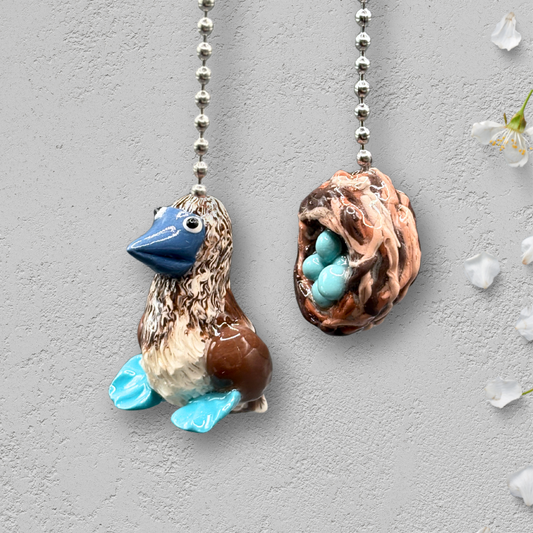 Two decorative ceiling fan pull chains with bird and nest design.