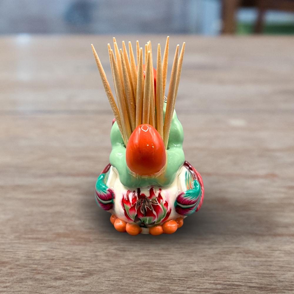 Colorful handmade polymer clay Dodo bird toothpick holder on a wooden surface