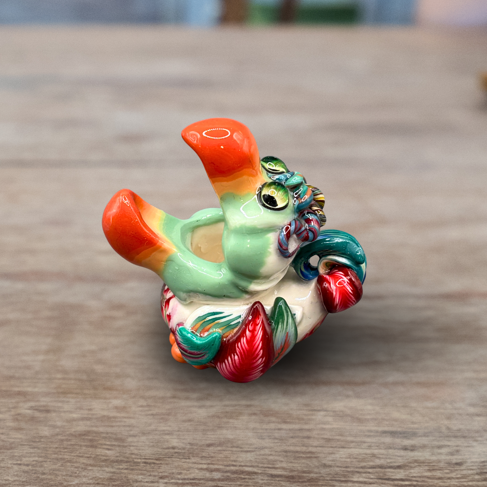 Colorful handmade polymer clay Dodo bird toothpick holder on a wooden surface