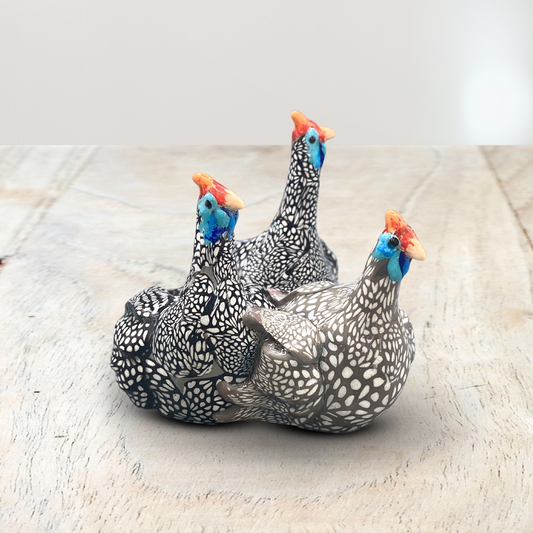 A sculpture of 3 Guinea Fowl adults made with Polymer clay