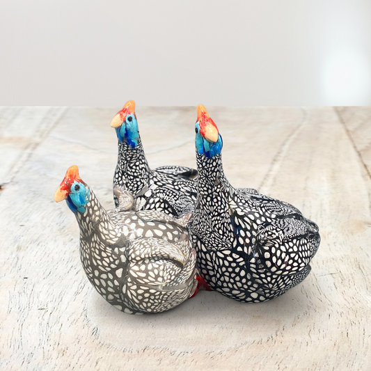 A sculpture of 3 Guinea Fowl adults made with Polymer clay