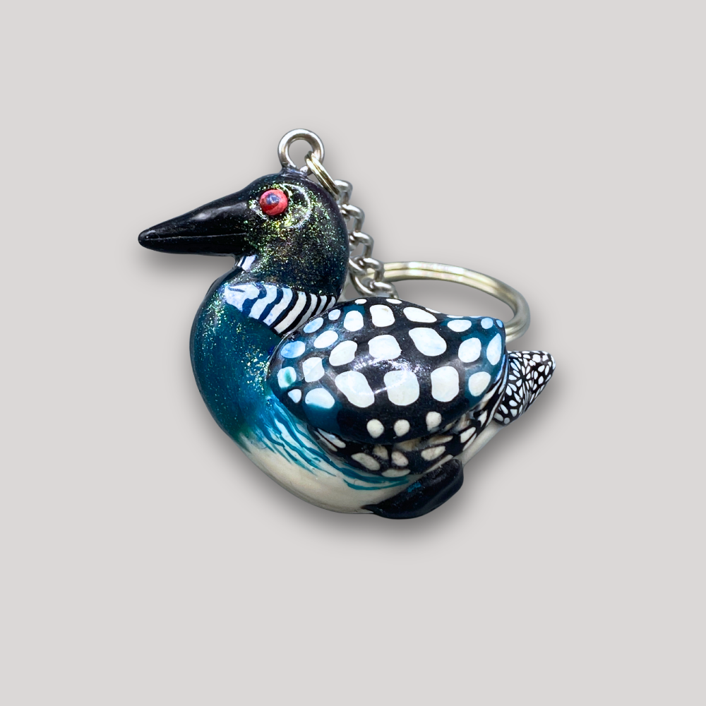 Keychain shaped like a loon bird on a light gray background