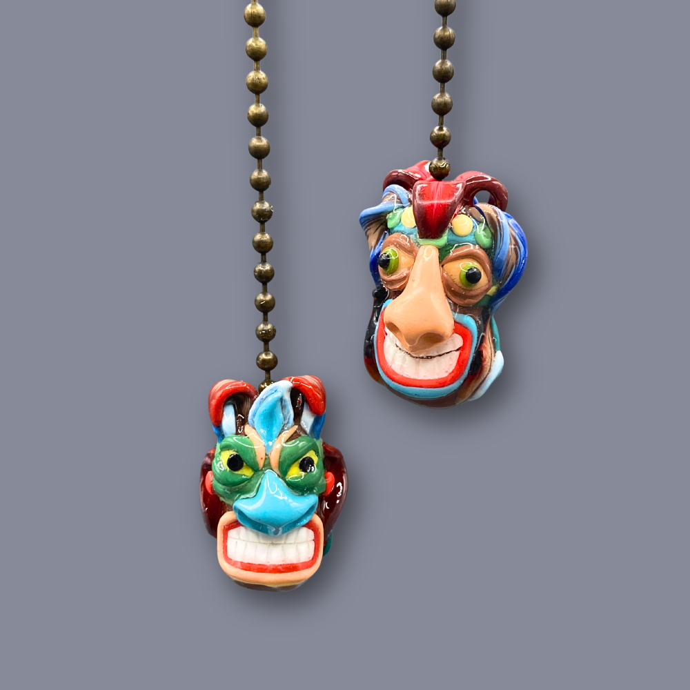 Colorful mask-shaped pull chain on a gray background